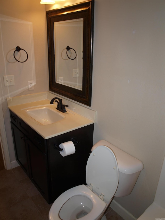 bathroom with tile patterned flooring, vanity, and toilet