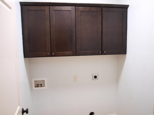 washroom with washer hookup, electric dryer hookup, and cabinets