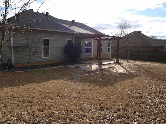 rear view of property with a yard, a pergola, and a patio area