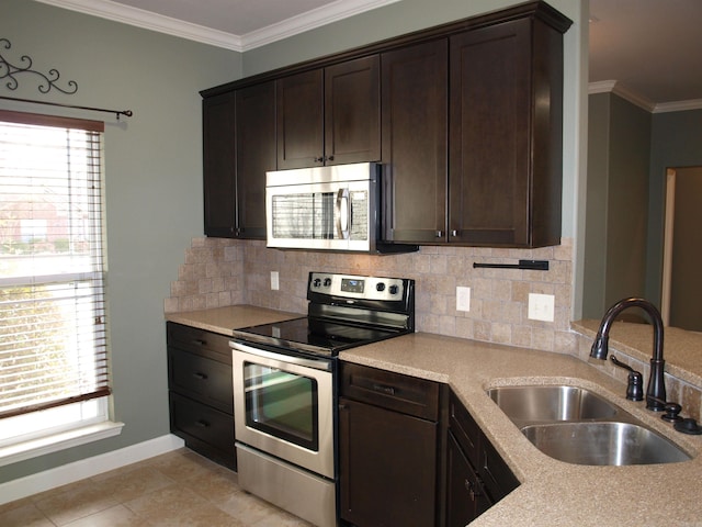 kitchen with decorative backsplash, dark brown cabinetry, stainless steel appliances, and sink