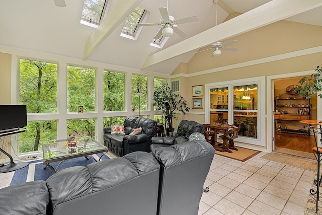 sunroom / solarium with ceiling fan, a healthy amount of sunlight, and lofted ceiling with skylight