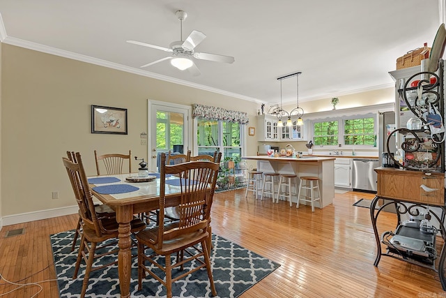 dining space featuring ceiling fan with notable chandelier, crown molding, and light hardwood / wood-style flooring