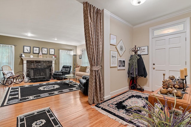 entryway with wood-type flooring, a premium fireplace, and crown molding