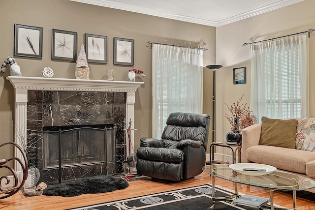 living room with wood-type flooring, a premium fireplace, and crown molding