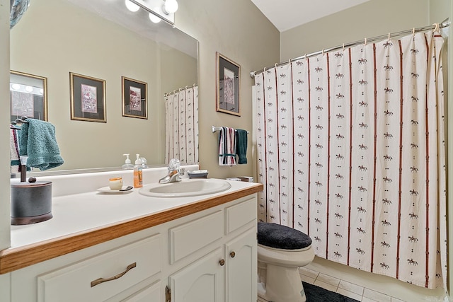 bathroom featuring tile patterned flooring, vanity, and toilet