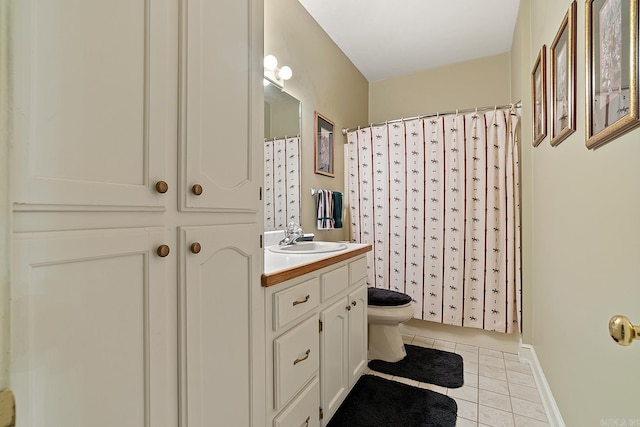 bathroom featuring tile patterned floors, vanity, and toilet