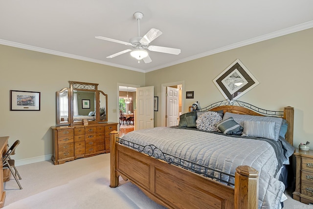 carpeted bedroom featuring ceiling fan and crown molding