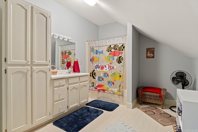 bathroom featuring a shower with curtain, vanity, and vaulted ceiling