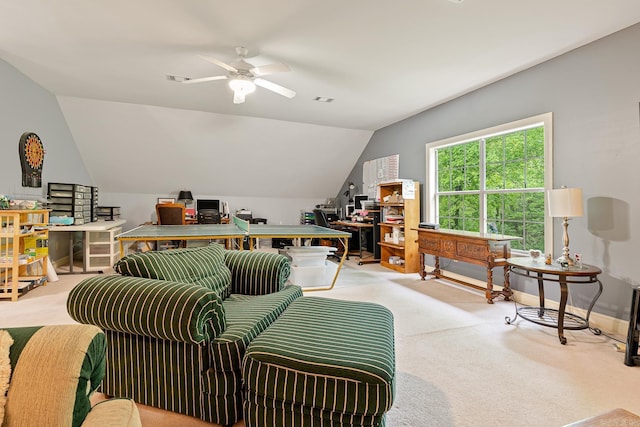 living room featuring ceiling fan, carpet floors, and vaulted ceiling