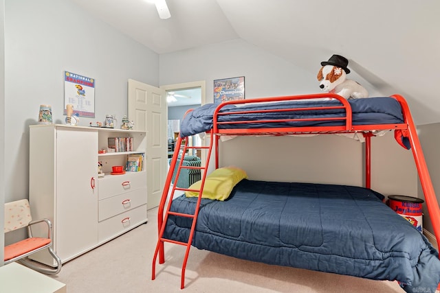 carpeted bedroom featuring ceiling fan and vaulted ceiling