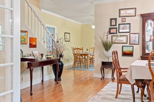 dining space with ceiling fan, light hardwood / wood-style floors, and ornamental molding