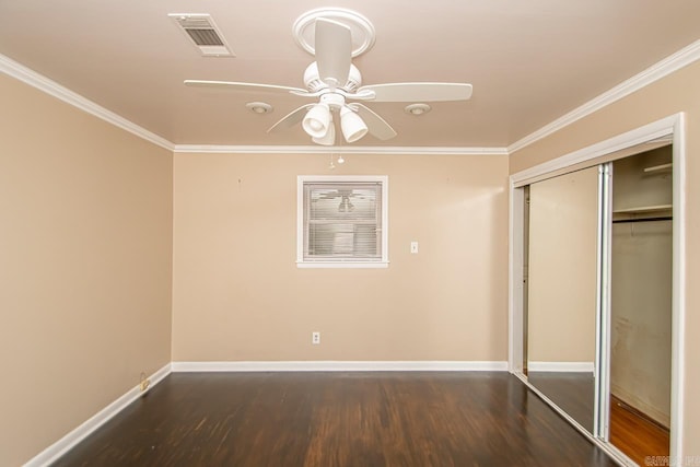 unfurnished bedroom with dark hardwood / wood-style flooring, ceiling fan, a closet, and ornamental molding