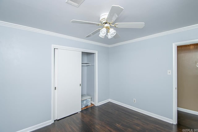 unfurnished bedroom with ceiling fan, dark hardwood / wood-style floors, ornamental molding, and a closet