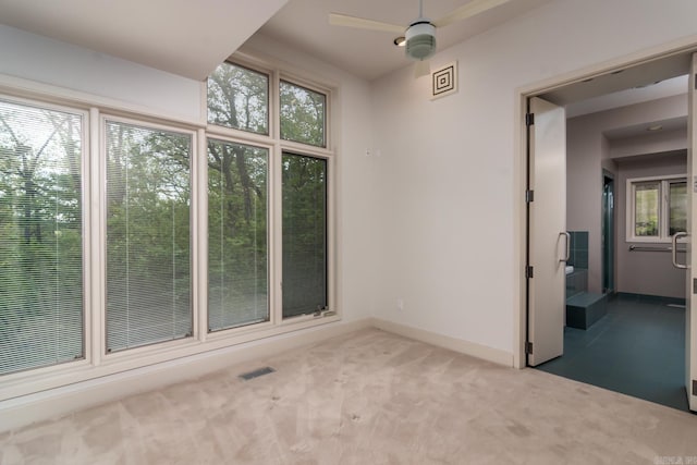 spare room with carpet floors and ceiling fan