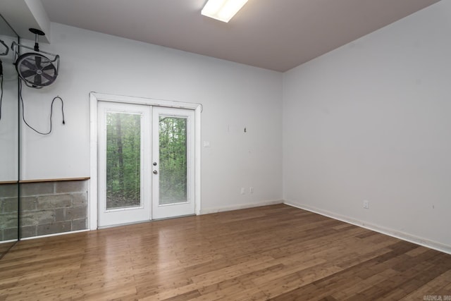 unfurnished room with wood-type flooring and french doors