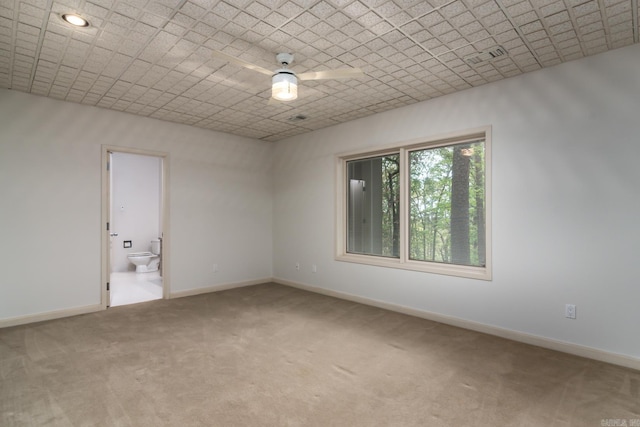 empty room featuring carpet flooring and ceiling fan