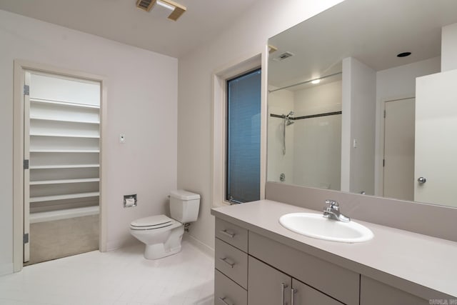 bathroom with vanity, toilet, and walk in shower