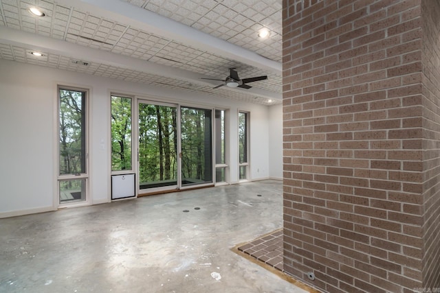 interior space with ceiling fan and concrete flooring