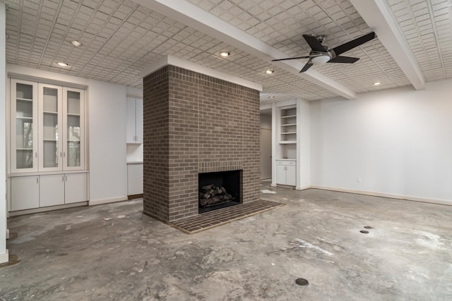 unfurnished living room featuring beamed ceiling, a brick fireplace, ceiling fan, and brick ceiling