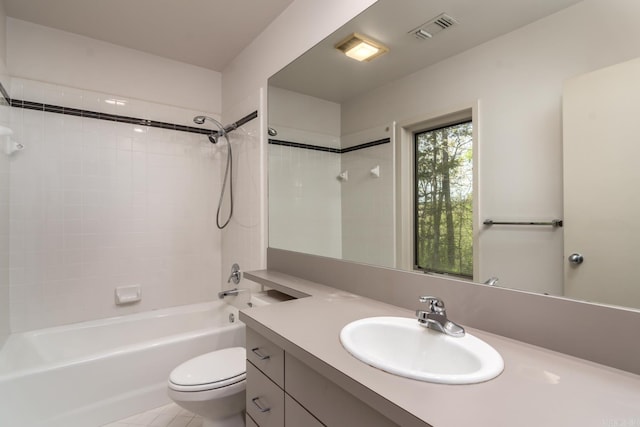 full bathroom with vanity, toilet, and tiled shower / bath combo