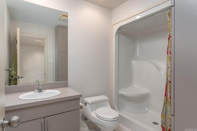 bathroom featuring vanity, toilet, and walk in shower