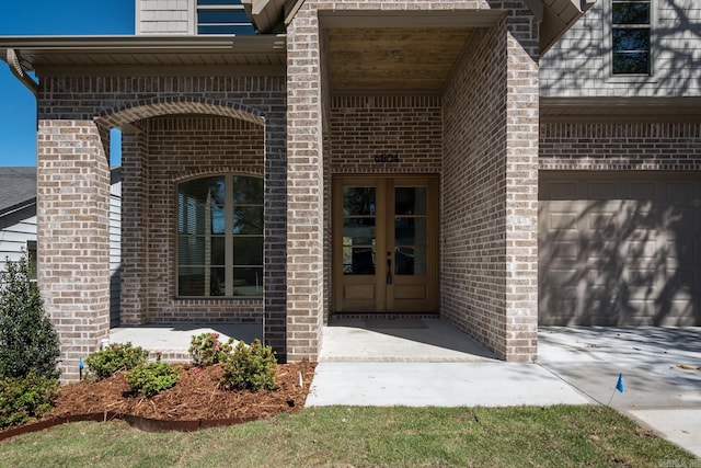 entrance to property with a garage and french doors