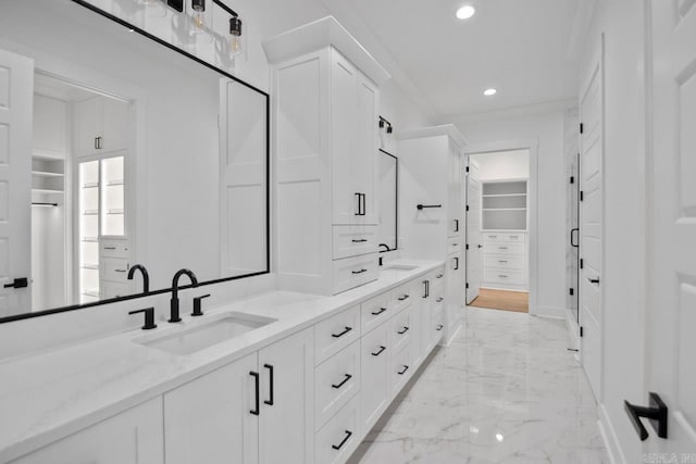 bathroom featuring crown molding and vanity