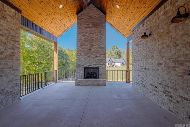 view of patio / terrace featuring an outdoor brick fireplace