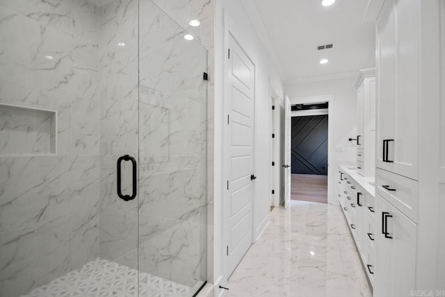 bathroom featuring ornamental molding, vanity, and a shower with shower door