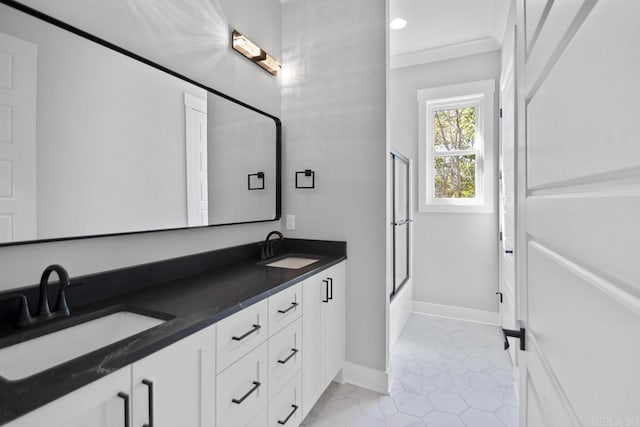 bathroom featuring tile patterned floors, vanity, and combined bath / shower with glass door