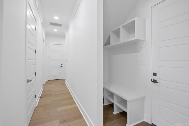 corridor featuring light hardwood / wood-style floors and ornamental molding