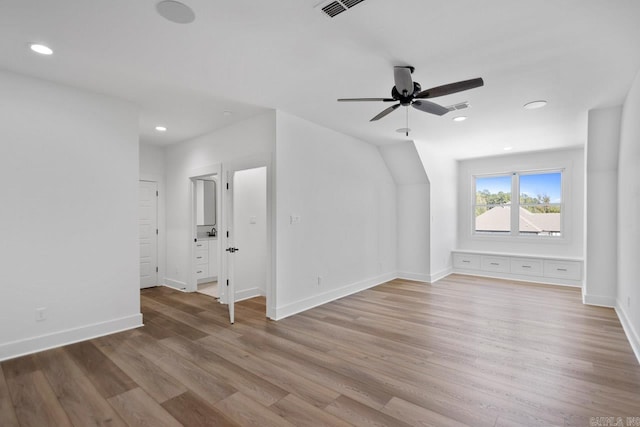 bonus room with ceiling fan and light wood-type flooring