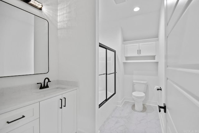 full bathroom featuring shower / bath combination with glass door, vanity, and toilet