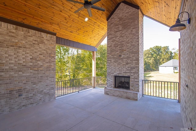 view of patio / terrace featuring an outdoor brick fireplace and ceiling fan