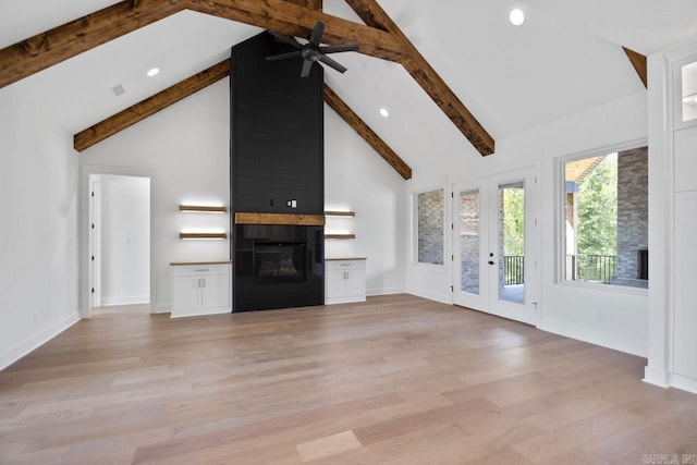 unfurnished living room with high vaulted ceiling, ceiling fan, light hardwood / wood-style floors, a fireplace, and beam ceiling