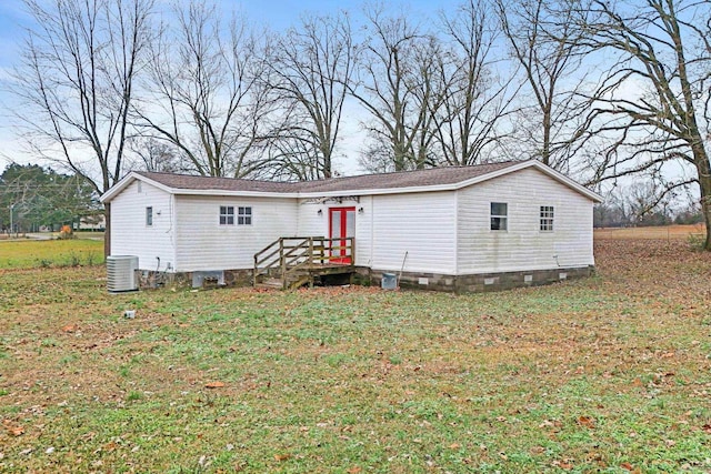 back of house with a lawn and central air condition unit