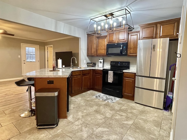 kitchen featuring a breakfast bar, black appliances, sink, ornamental molding, and kitchen peninsula