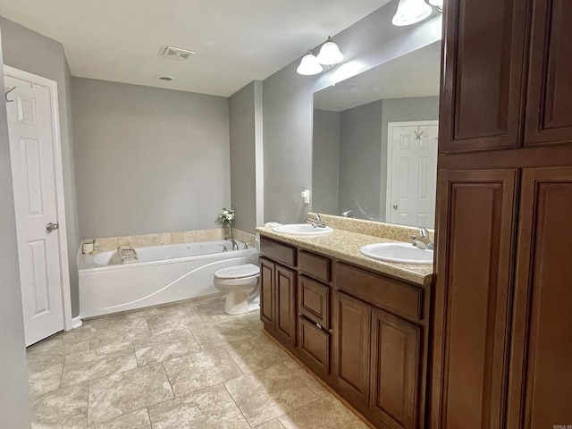 bathroom featuring a washtub, toilet, and vanity