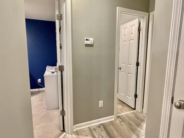 hallway with light hardwood / wood-style flooring