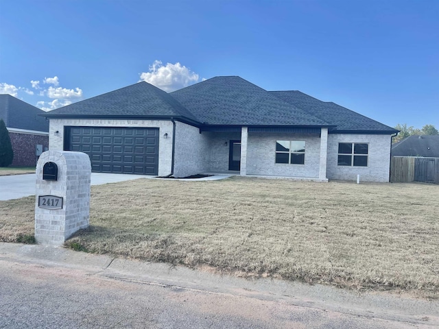 view of front of house with a garage and a front lawn