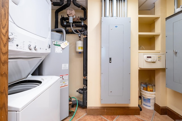 laundry room featuring light tile patterned floors, electric panel, and stacked washer and clothes dryer