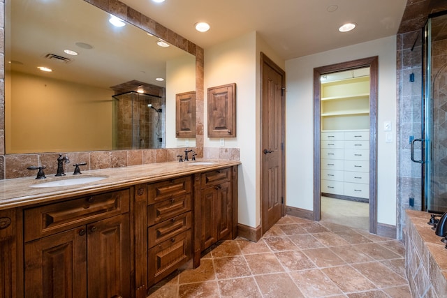 bathroom featuring vanity and a shower with door