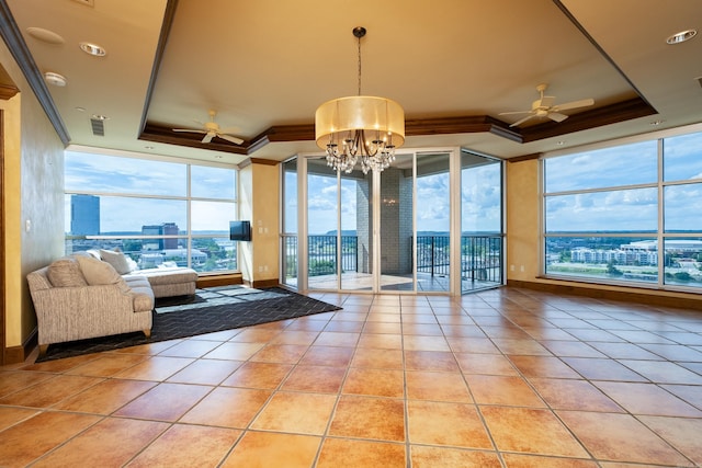 interior space with crown molding, light tile patterned floors, a tray ceiling, and ceiling fan with notable chandelier