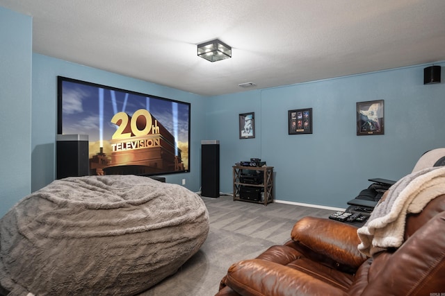 carpeted home theater room with a textured ceiling