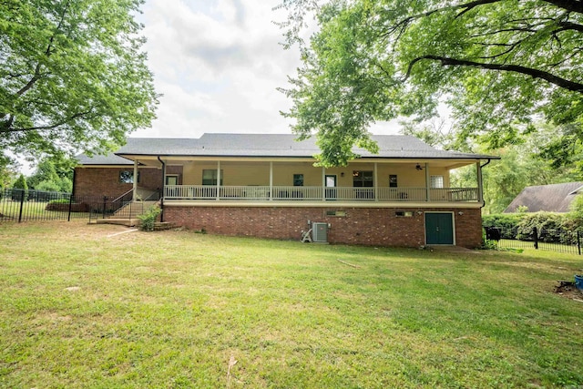 back of house featuring cooling unit and a yard