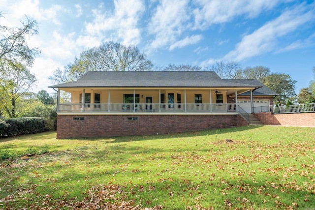 view of front of home with a porch, a front yard, and a garage