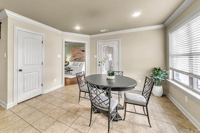 dining area featuring light tile patterned flooring and crown molding