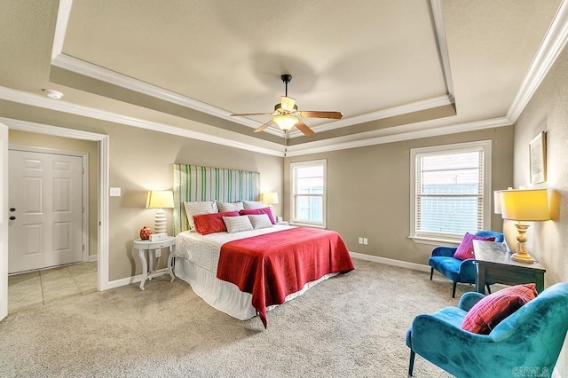 bedroom featuring multiple windows, a tray ceiling, and ceiling fan