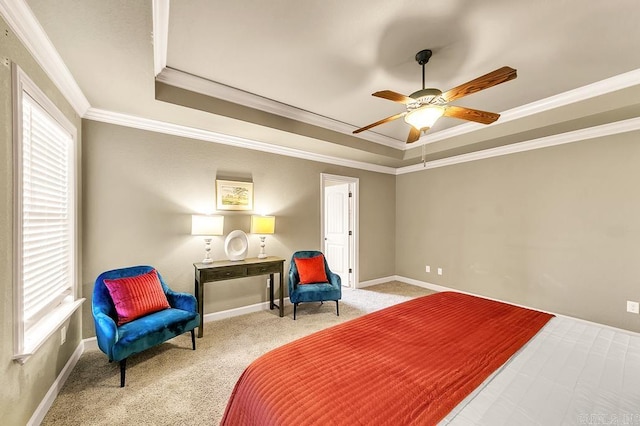 carpeted bedroom featuring a raised ceiling, ceiling fan, and crown molding