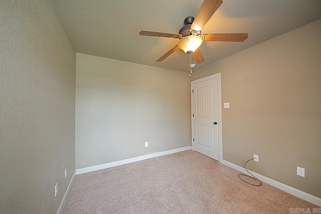 unfurnished room with ceiling fan and carpet floors